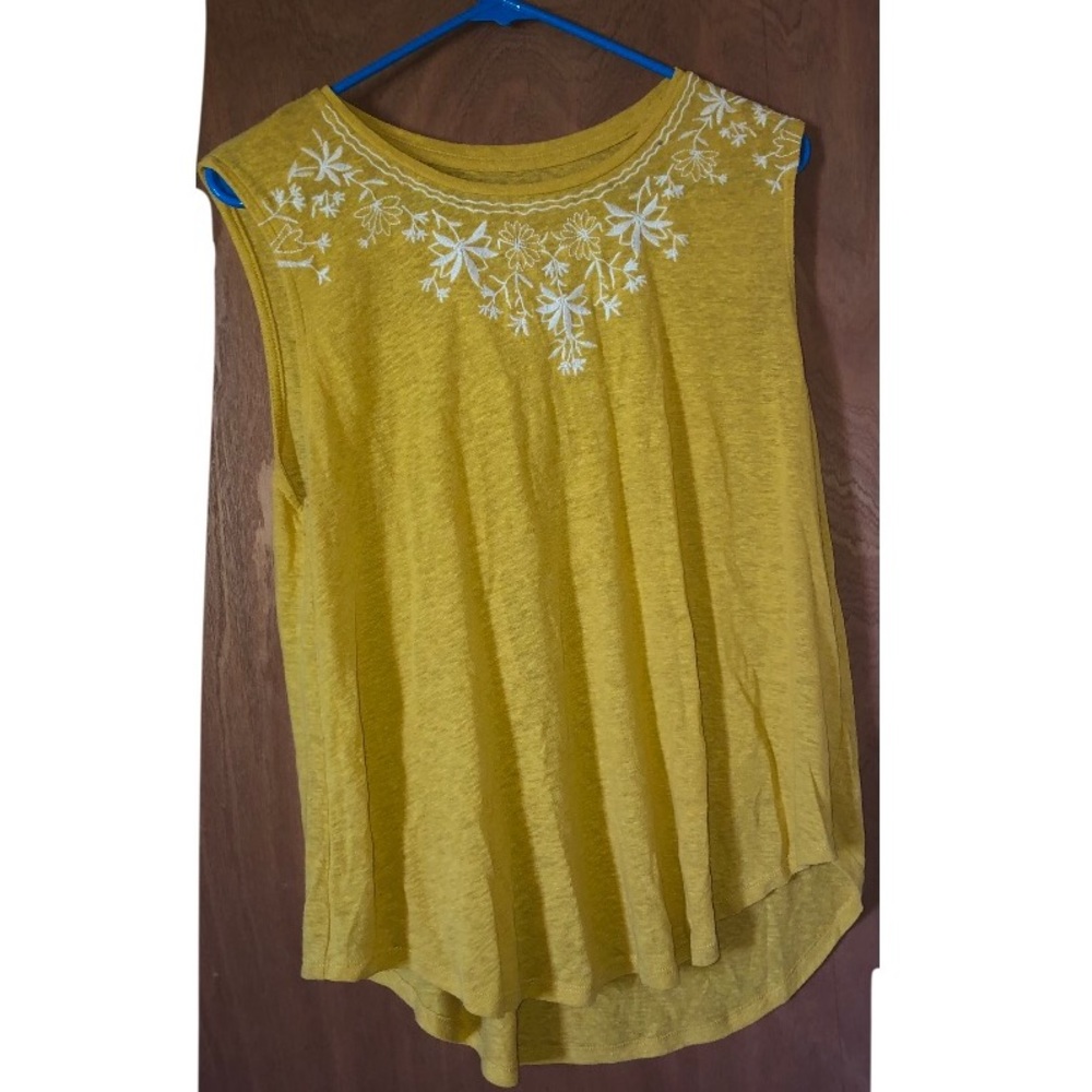 A yellow with white flowers shirt from old navy in the size large
